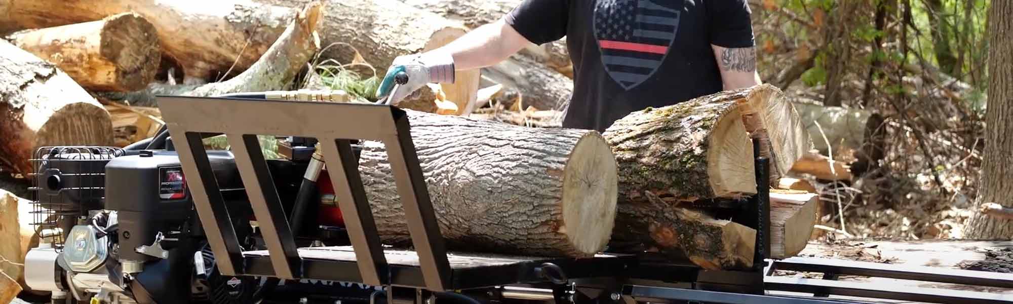 Large logs being split with 4-way wedge on a log splitter